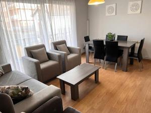 a living room with a couch and a table and chairs at Del Marqués in Las Navas del Marqués