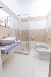 a bathroom with two sinks and a shower at Sibari Residence in Marina di Sibari