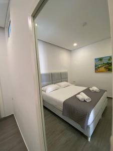 a bedroom with a bed and a large mirror at Edina in Sarandë