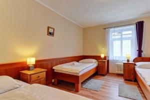 Postel nebo postele na pokoji v ubytování Penzion pod Radyni