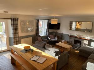 a living room with a couch and a table at Tay Bunkhouse in Pitlochry