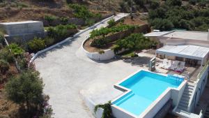an aerial view of a house with a swimming pool at Villa Kefali in Kavoúsion