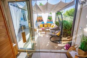 a room with a sliding glass door leading to a patio at Villa NONO Jure - Private Pool & Jacuzzi, Milna Brač in Milna