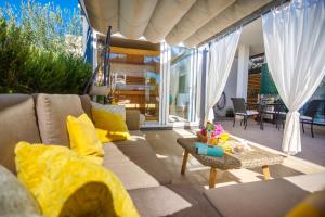 a living room with a couch and a table at Villa NONO Jure - Private Pool & Jacuzzi, Milna Brač in Milna +27 photos