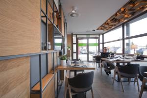 a man sitting at a table in a restaurant at Link Hotel in Tczew