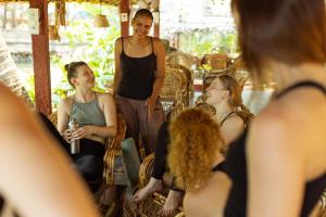 a man standing in front of a group of women at Palm Trees Ayurvedic Heritage in Patnem