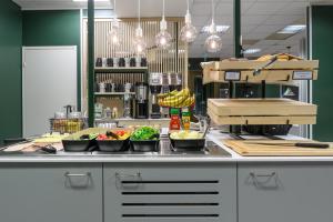 a kitchen with bowls of food on a counter at GreenStar Hotel Oulu in Oulu