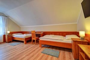 Postel nebo postele na pokoji v ubytování Penzion pod Radyni