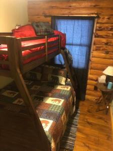 a bedroom with two bunk beds in a cabin at APPLEJAX cabin steps from a u pick orchard in Sandisfield