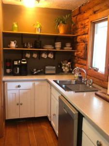 a kitchen with a sink and a counter top at APPLEJAX cabin steps from a u pick orchard in Sandisfield