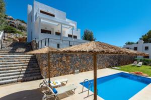 a villa with a swimming pool and a house at Aggellina Villa in Pefki Rhodes
