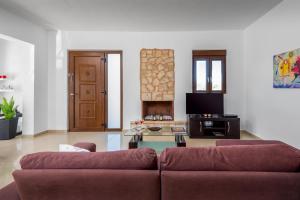 a living room with a couch and a table at Aggellina Villa in Pefki Rhodes