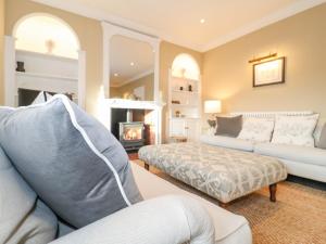 a living room with a couch and a fireplace at The Middle House in Southwold