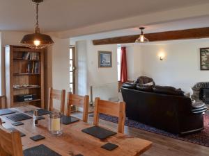 a living room with a table and a couch at Bryn Golau in Llanfaethlu