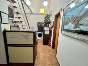 a hallway with a washer and dryer in a building at Penzion Félix in Topoľčany