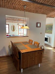 een keuken en eetkamer met een houten tafel en stoelen bij Hlinné v Orlických horách in Dobré