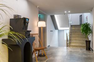 a hallway with stairs and a chair and a lamp at Songdo The Seoleim Hotel Stay in Incheon +48 photos