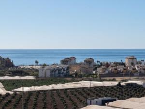 a resort with white umbrellas and the ocean at Villa Maritim in Torrox