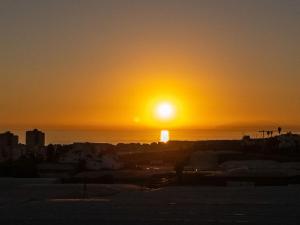a sunset over the ocean with the sun in the sky at Villa Maritim in Torrox