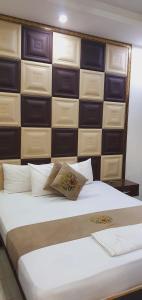 a bedroom with a large white bed with a wall of drawers at Park View Hotel Gulberg in Lahore