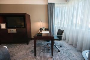 a hotel room with a desk and a television at InterContinental Lisbon, an IHG Hotel in Lisbon