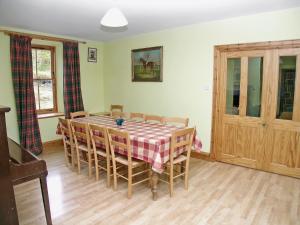 a dining room with a table and chairs at Mar House in Braemar