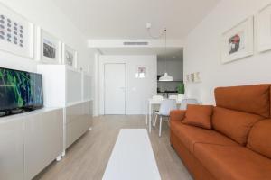 a living room with a couch and a tv at Apartamentos Mercado Central in Valencia