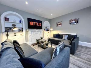 a living room with a couch and a fire place at Luxury Harrogate Flat with Free Parking in Harrogate
