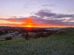 a sunset on top of a hill with the sun setting at The Loft, Killybegs in Donegal