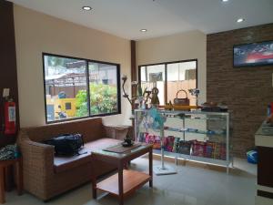 a living room with a couch and a table at DIAKOPES INN in Puerto Princesa City
