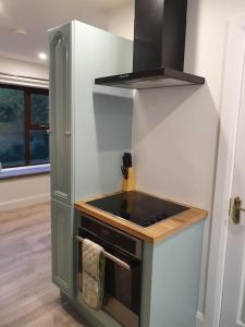 a kitchen with a stove and a stove top oven at The Loft, Killybegs in Donegal