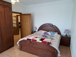 a bed with a wooden frame in a bedroom at Three bedrooms apartment Nile view maadi in Cairo