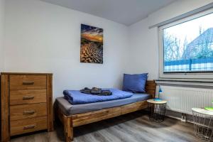 a small bedroom with a bed and a window at Küsters Ferienhaus Tinchen in Norden