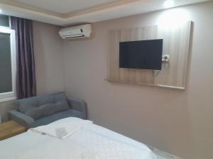 a hotel room with a bed and a tv on a wall at Moon Suit Hotel in Istanbul
