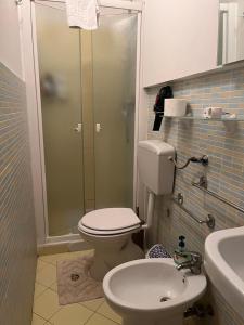 a bathroom with a shower and a toilet and a sink at Nuovo Cortile Palermo Bed and Breakfast in Palermo