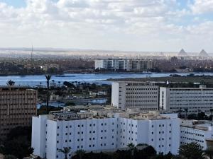 uitzicht op een stad met een rivier en gebouwen bij Three bedrooms apartment Nile view maadi in Caïro