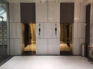 a lobby of a building with glass doors at THE PARKQUEEN in Rohtak