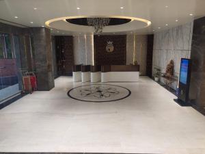 a large room with a lobby with a large ceiling at THE PARKQUEEN in Rohtak +13 photos