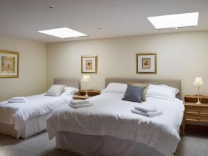 a bedroom with two beds and two lamps at The Old Dairy - Ukc3413 in Bolton by Bowland