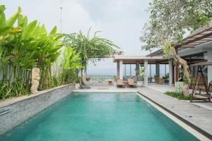 a swimming pool in the backyard of a house at The Lavana Villa Puri Hawila Jimbaran - 5 Bedroom Villa in Jimbaran