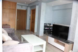 a living room with a couch and a flat screen tv at Belle Vue in Rabat