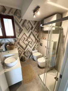 a bathroom with two toilets and a glass shower at Blue Holiday da Marco in Letojanni