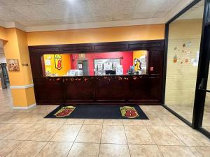 a restaurant with a front door with a counter at Super 8 by Wyndham Harrison OH in Harrison