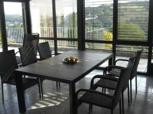 a table with chairs and a bowl of fruit on it at Ferienwohnung Alter Weinberg in Saarburg