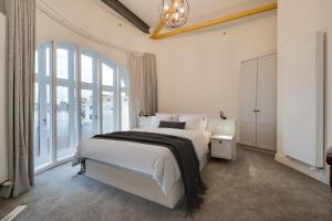 a bedroom with a large bed and a large window at Castle Buildings Serviced Apartments in Belfast