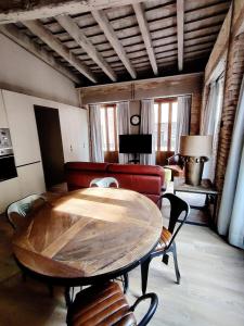 un soggiorno con tavolo in legno e divano di Apartment Plaza de la Merced a Valencia