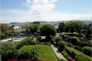 a view of a garden with bushes and trees at St Katherines in Llandudno