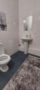 een badkamer met een toilet en een wastafel bij Апартаменты на 14 этаже ЖК АРАЙ in Aqtöbe