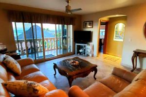 a living room with a couch and a coffee table at 5 bedroom Beachfront pool & Spa in Ensenada