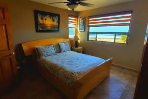 a bedroom with a bed and a window at 5 bedroom Beachfront pool & Spa in Ensenada +37 photos